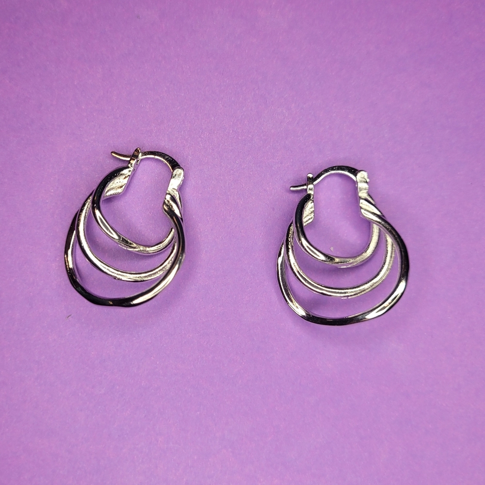 Set of silver plated 3 layer hoops, snap closure earrings. Brand new.